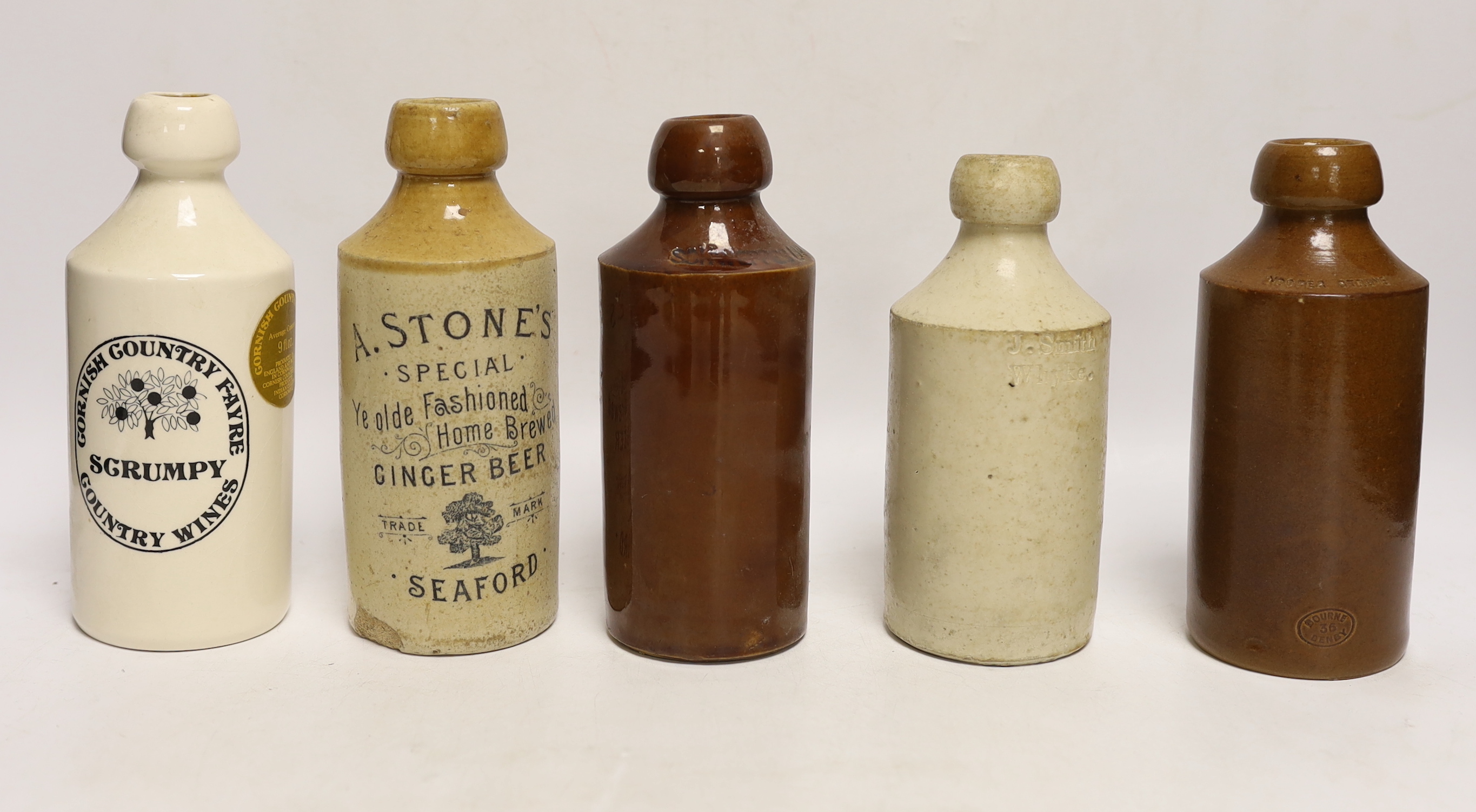 Early 20th century stoneware ginger beer bottles, one Hurstpierpoint, one Horsham, two Seaford and four others